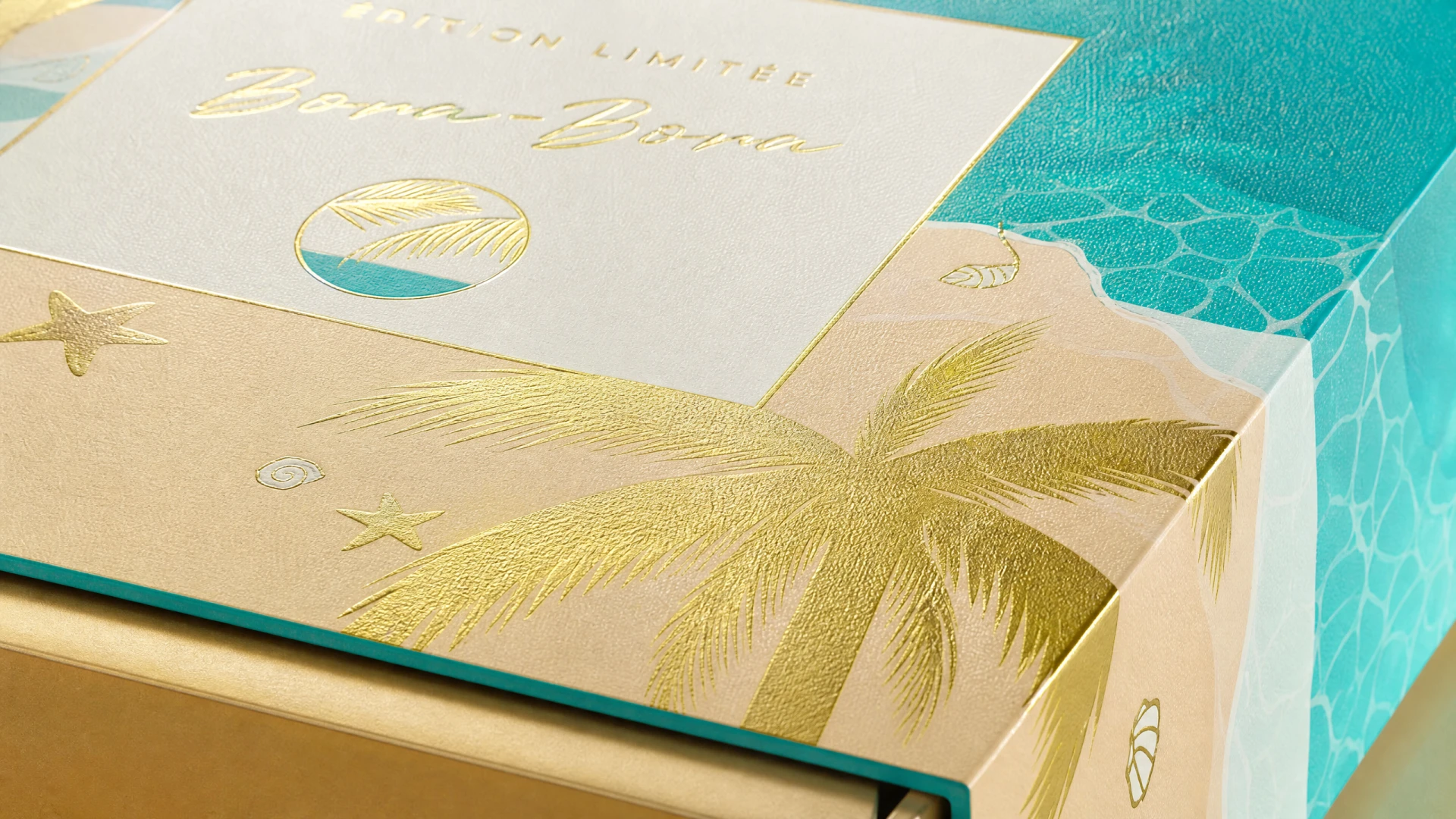 Close-up of the Bora-Bora box corner, palm motif and paper surface.